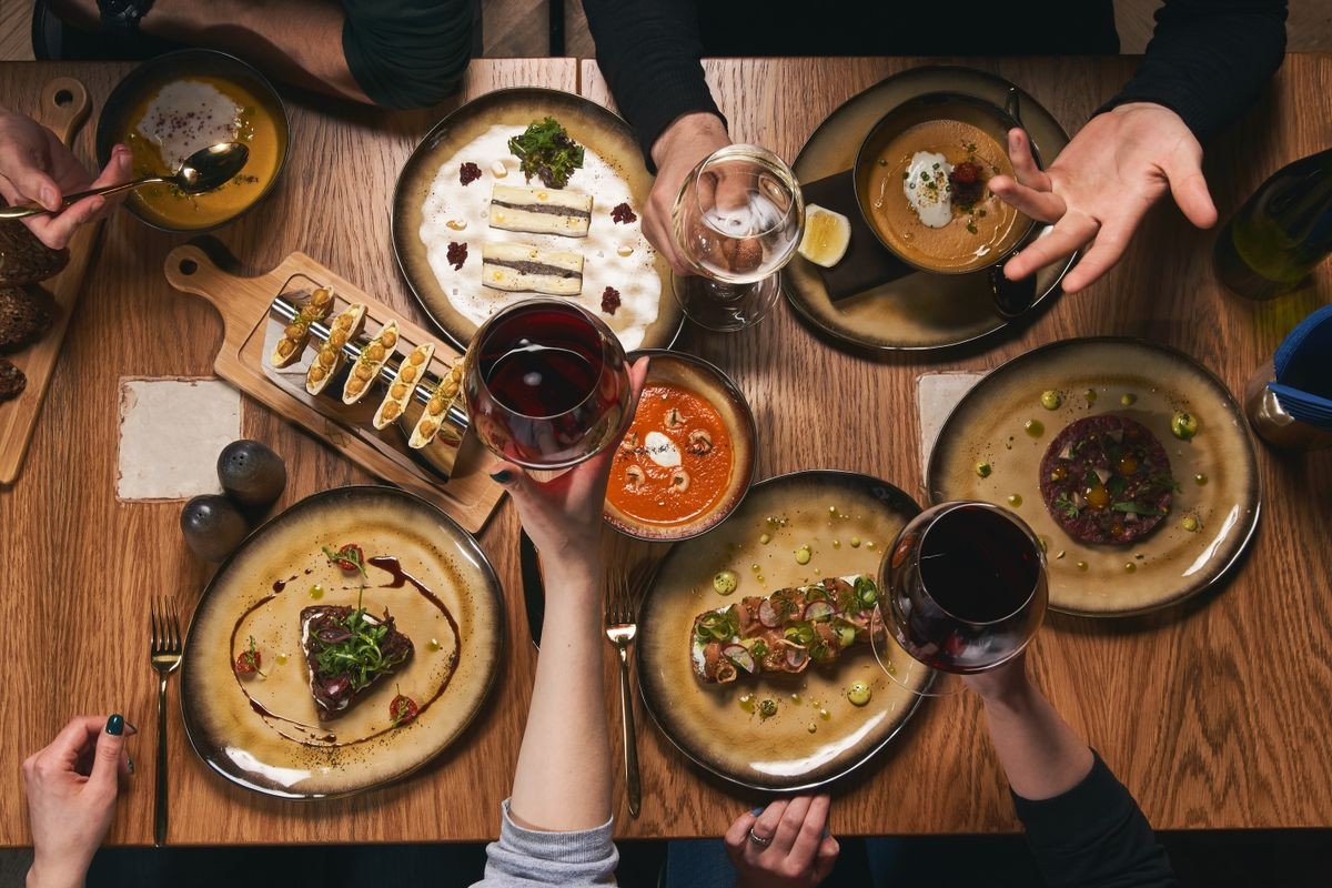 Table with food, top view. Group Of People Dining Concept